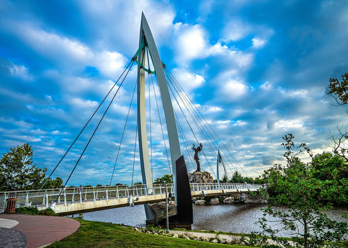 AdobeStock_357515456-Keeper of the Plains Sculpture and Bridge over Arkansas River Wichita Kansas