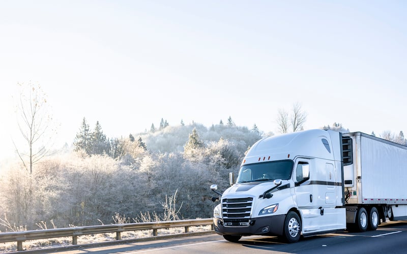 White truck driving on winter roads