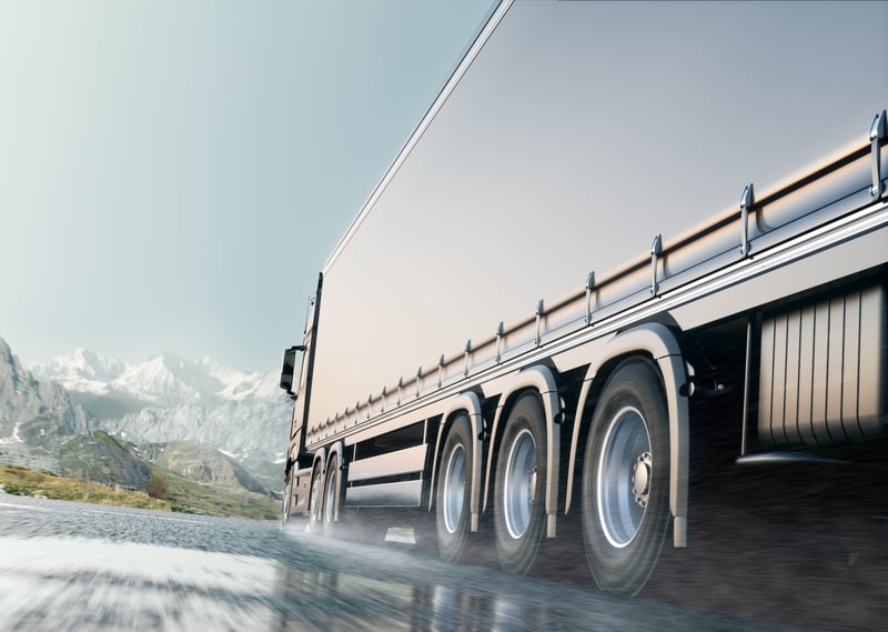 Side view of semi truck driving on the road