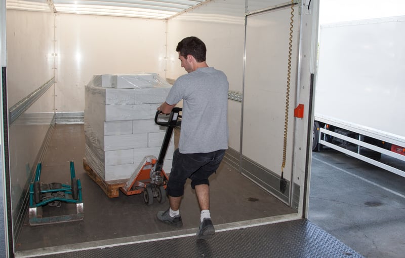 Person unloading cargo from truck