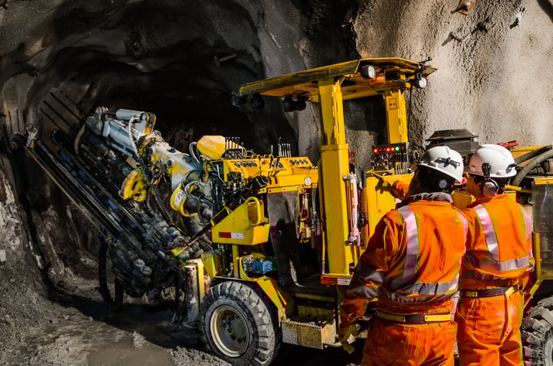 Mining workers and heavy machinery