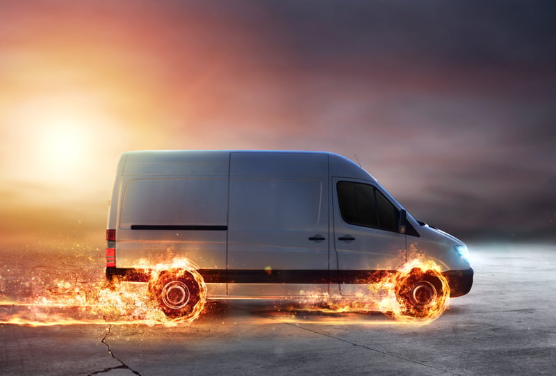 Sprinter van with flaming wheels moving fast