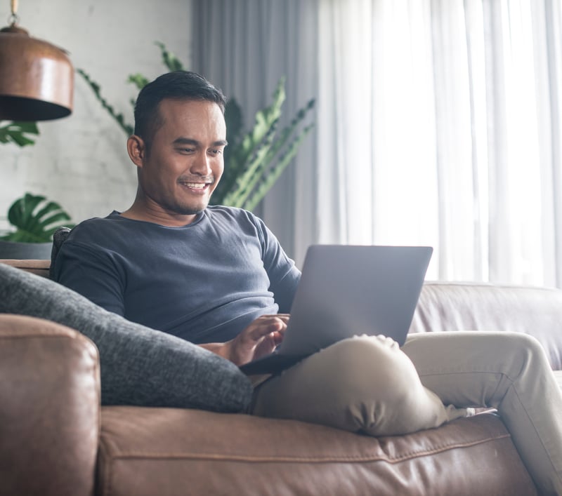 Man using laptop on couch