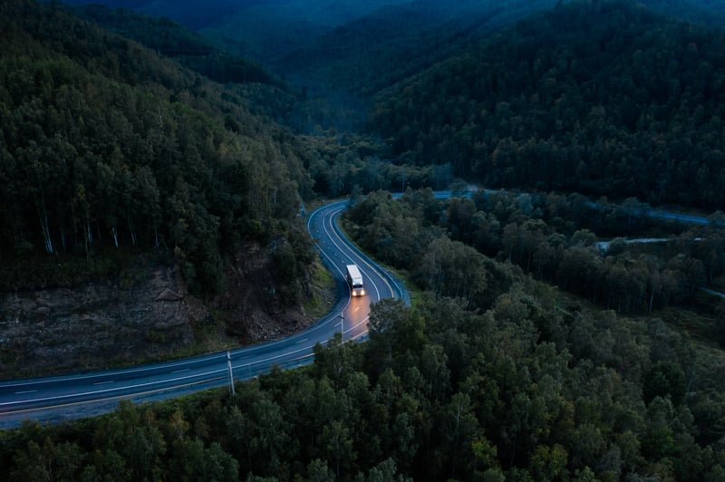 Truck driving on a winding road at night