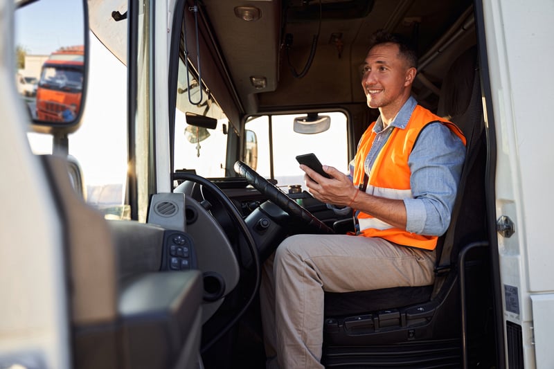 Happy truck driver in cab