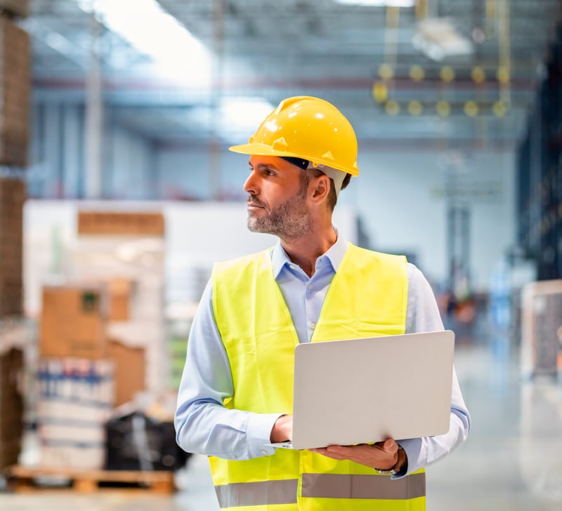 Man using laptop in manufacturing industry