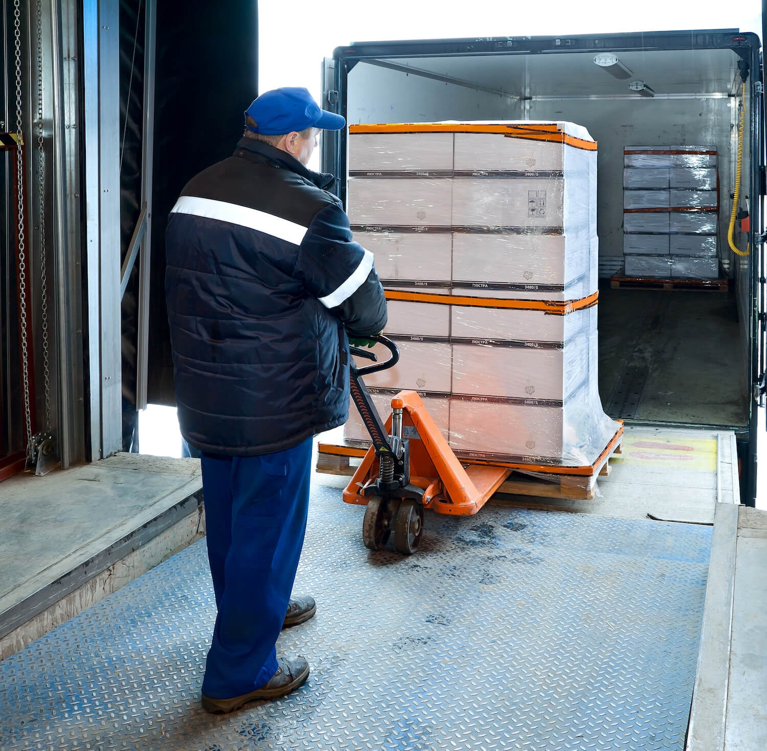 Cargo worker moving packages to truck
