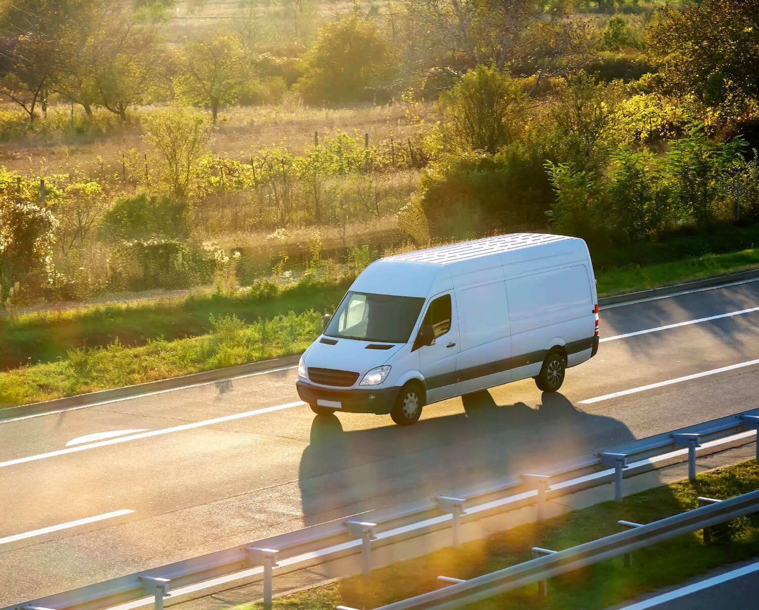 White modern delivery small shipment cargo courier van moving fast