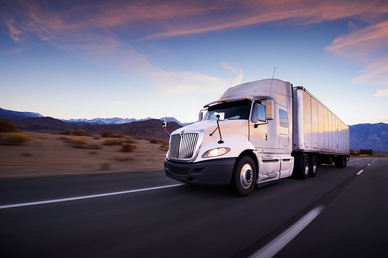 Truck and highway at sunset