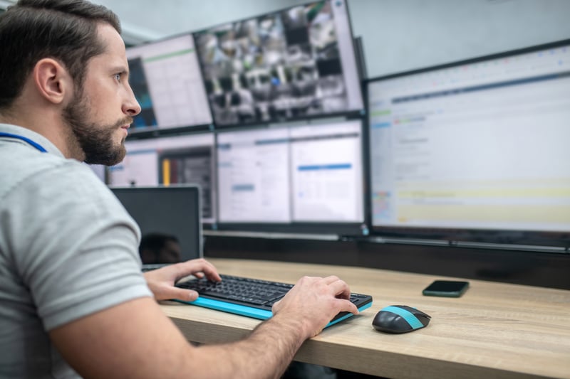 Agent working at desk with computer screens