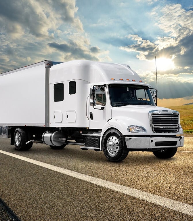 white truck driving on the road