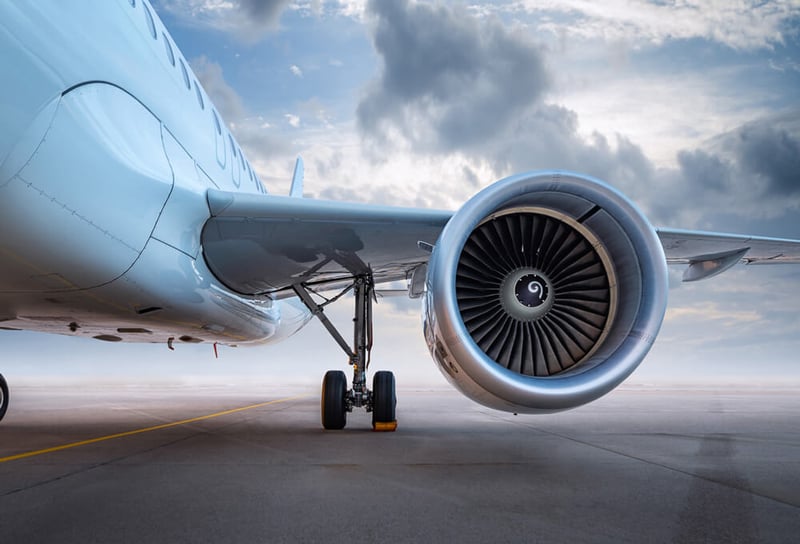 A turbine on a plane that's on a runway