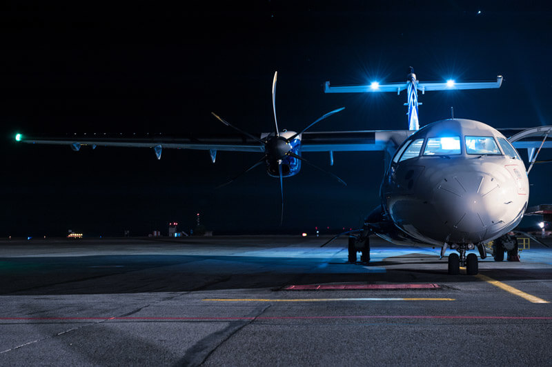 Plane on a runway at night